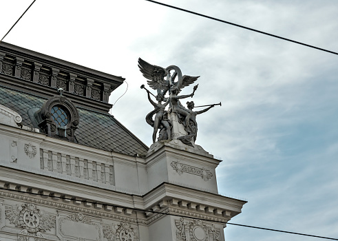 group of figures on the roof of the historic building of the main railway station in Brno, Czech Republic