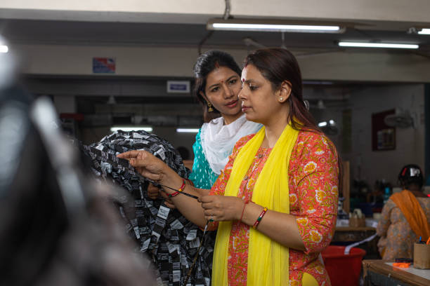 istock Manager and workers selecting fabrics in textile factory 1493192274