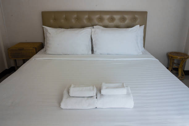 istock White comfortable pillow on white bed decoration interior of hotel bedroom. 1493192887