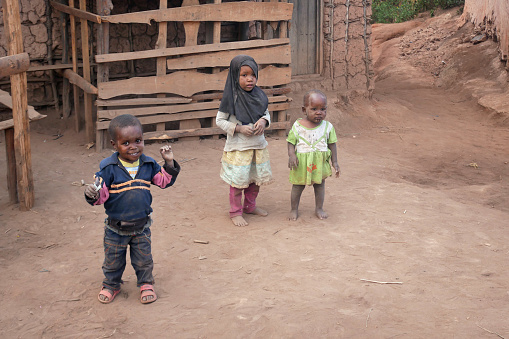 Usambara Mountains, Tanzania – 02.09.2023: Dirty children in a village pose for a picture