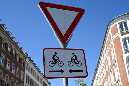 Traffic sign indicating a give way and a crossing of a cycle path in both directions