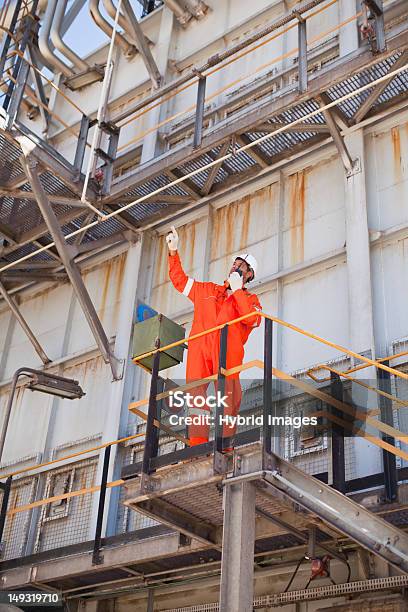 Worker With Walkie Talkie On Site Stock Photo - Download Image Now - Oil Refinery, 40-44 Years, Adult