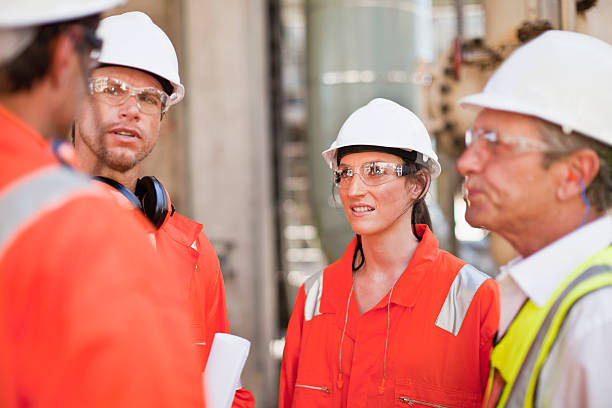 Workers walking at oil refinery  safety glasses stock pictures, royalty-free photos & images