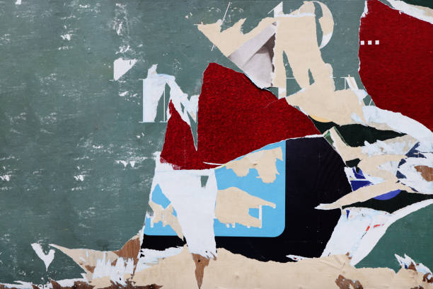 istock Pieces of torn paper peeling off wall used as billboard 1493197788