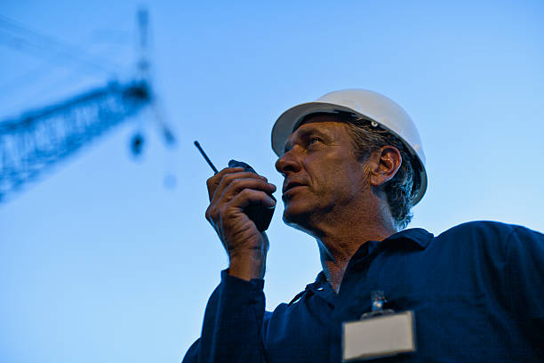 Worker using walkie talkie on site  walkie talkie photos stock pictures, royalty-free photos & images