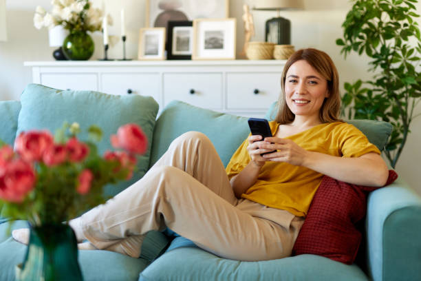istock Woman using smartphone while drinking coffee at her home in the morning 1493199160