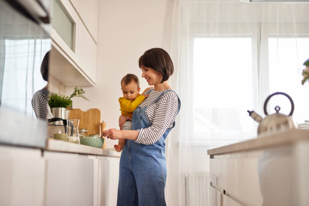 istock Mother and baby boy in the kitchen preparing breakfast 1493199993