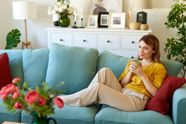 istock An attractive young woman relaxing at home drinking coffee 1493200696