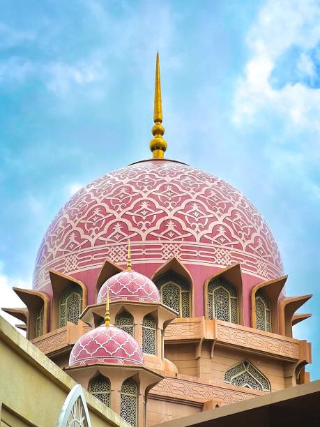 istock Pink-domed mosque stands out against a bright blue sky 1493201873