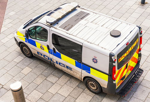 A view from above a UK police van in a city centre.