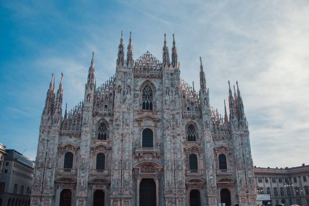 istock people walk around outside a building with tall cathedrals in the background 1493202761