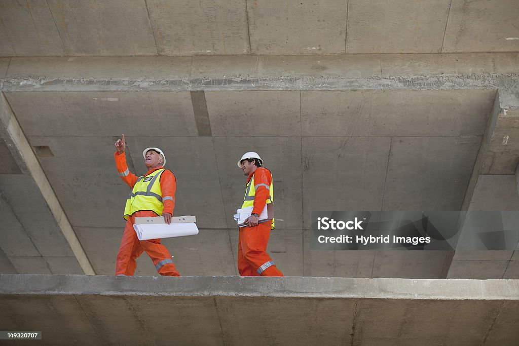 Workers walking at construction site  At The Edge Of Stock Photo