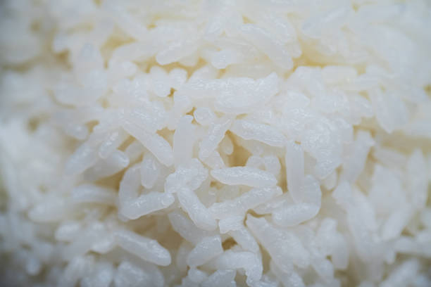 A bowl of rice on a wooden board macrophotography