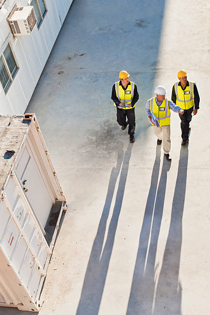 Workers casting shadows on site  industrial labourer stock pictures, royalty-free photos & images