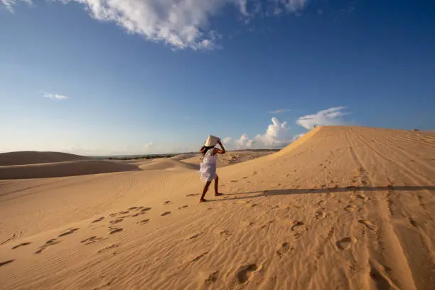 Portrait Young Asian Woman travel, On White Sand dune desert Muine, in Vietnam