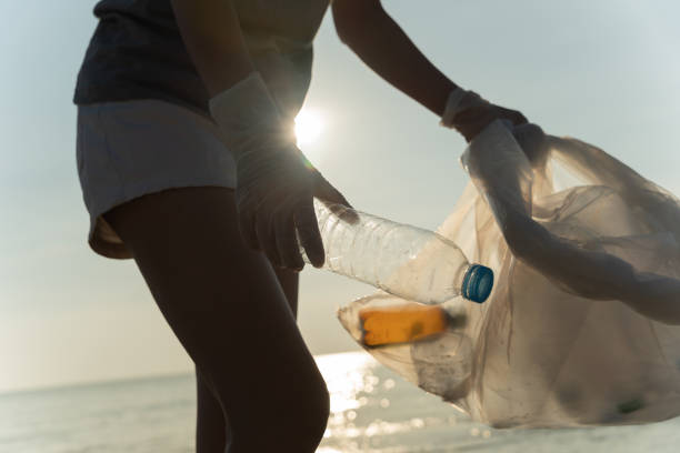 istock Save water. Volunteer pick up trash garbage at the beach and plastic bottles are difficult decompose prevent harm aquatic life. Earth, Environment, Greening planet, reduce global warming, Save world 1493209741