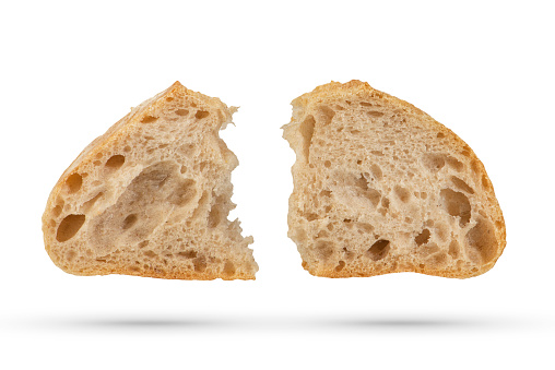 Two slices of fresh Ciabatta bread on a white isolated background. Slices hang or fall on a white background. The concept of Italian bread baking or delicious breakfast