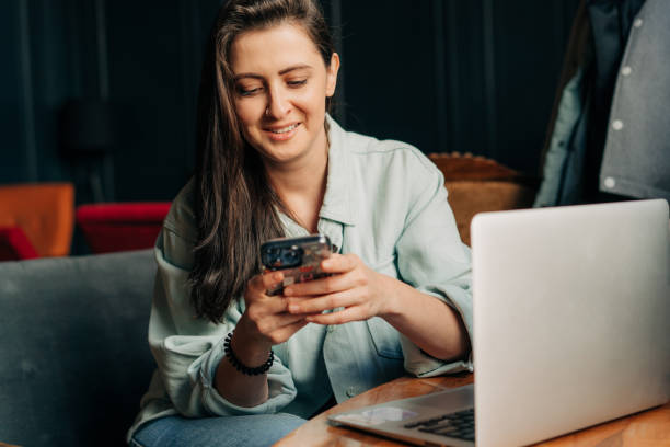 istock Happy smiling woman is using mobile phone for online chat. 1493217513