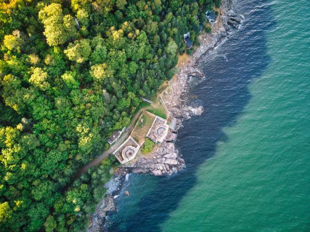 istock a large white house sitting on top of a rocky shore 1493218543