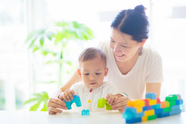 istock Baby boy  and mother playing with toy 1493220296
