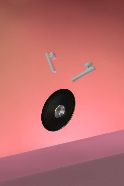istock Earphones bluetooth, speaker levitation on pink background. 1493223738