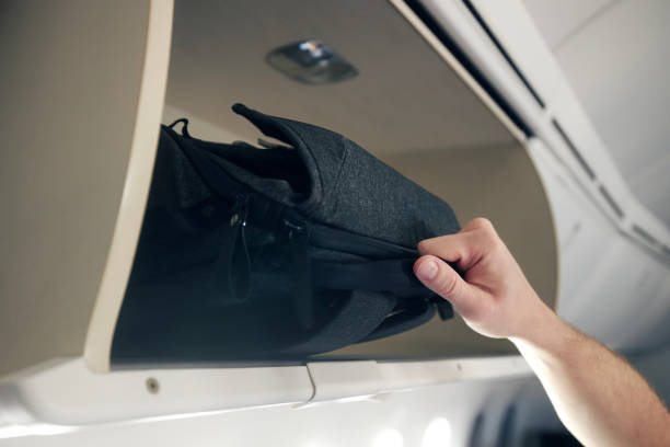 istock Hand of passenger is putting hand baggage in lockers 1493225688