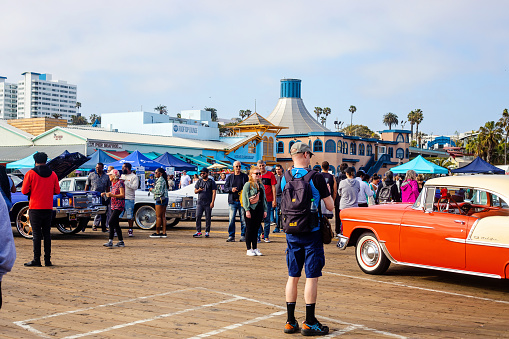 Santa Monica, United States - May 19, 2023. People gather at a classic car show on Santa Monica Pier