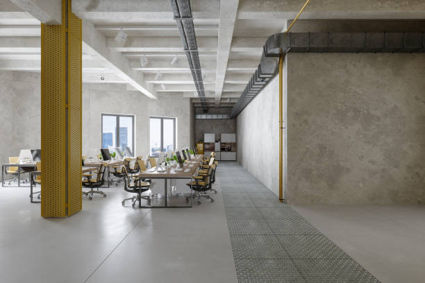 Industrial Style Open Plan Office Interior With Tables, Computers And Yellow Office Chairs. Cityscape Through The Window