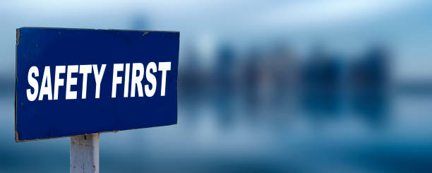 Safety First sign with blurred city  background