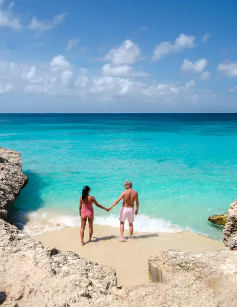 Tres Trapi Steps Triple Steps Beach, Aruba completely empty, Popular beach among locals and tourists for diving and snorkeling, couple man and woman in a crystal clear ocean in the Caribbean