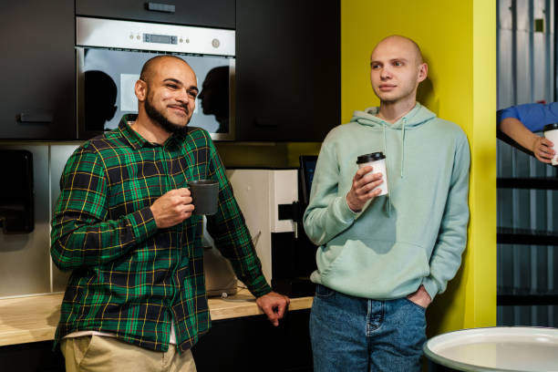 istock Two male colleagues having a talk while coffee break in office 1493239651