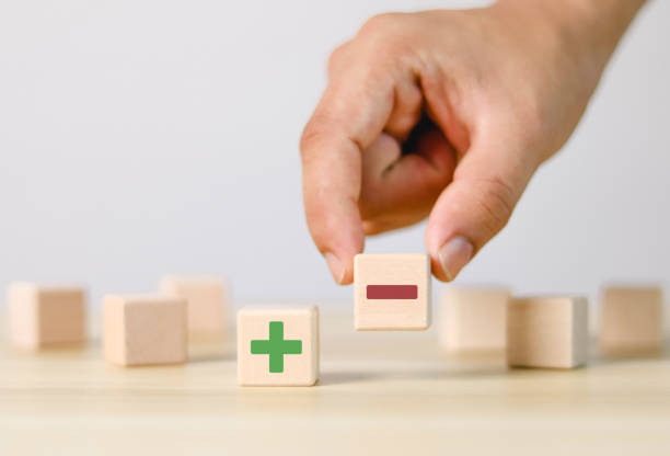 istock Hands and plus minus green on wooden blocks 1493242583