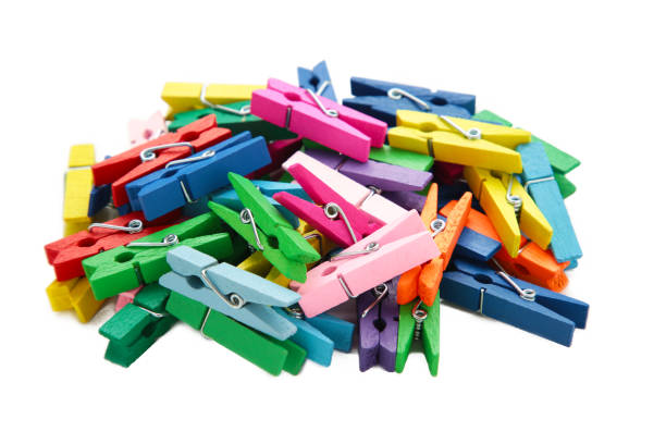 istock Colored wooden clothespins isolated on white background. Design elements. Macro. 1493246221