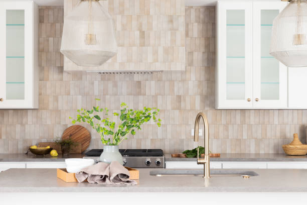 istock A kitchen faucet detail with a brown tiled backsplash behind. 1493247018
