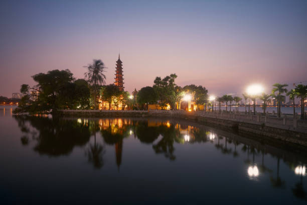 West lake and water reflection of illuminated Tran Quoc Pagoda - the oldest Buddhist temple in Hanoi at twilight, Vietnam.