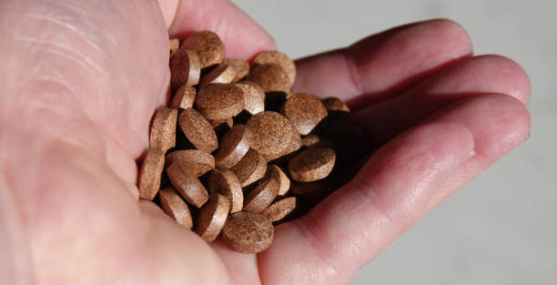 istock A handful of brown coloured multi-vitamin tablets. 1493251475