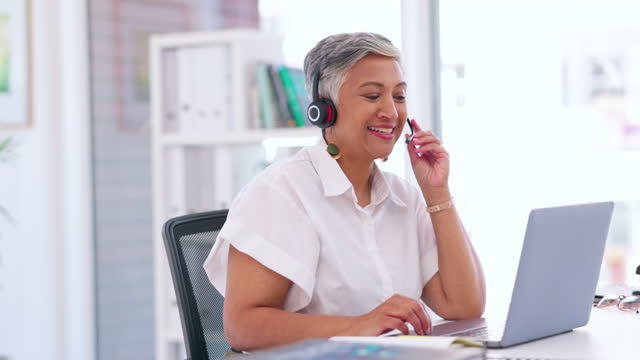 Talking business woman, laptop or call center headset in CRM office, customer support company or b2b sales telemarketing. Smile, happy or mature receptionist on technology for lead generation service