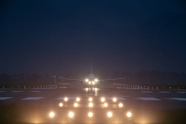 istock passenger plane takes off at night, airfield lights 1493260655