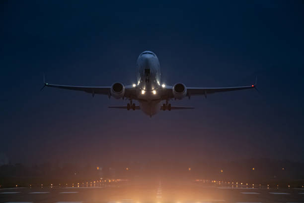 istock passenger plane takes off at night, airfield lights 1493260836