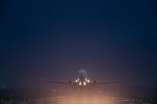istock passenger plane takes off at night, airfield lights 1493260837