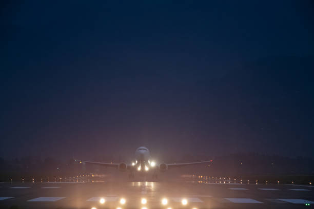 istock passenger plane takes off at night, airfield lights 1493260838