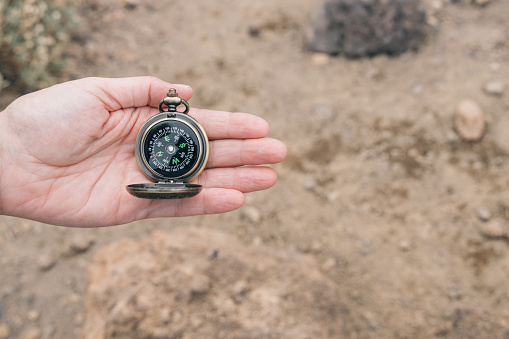 Compass held by the hand of an unrecognizable woman