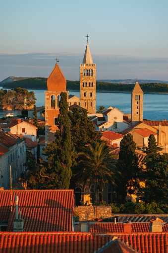 Beautiful view on towers, littoral trees and house rooftops in Rab old town at dusk, Rab island in Croatia