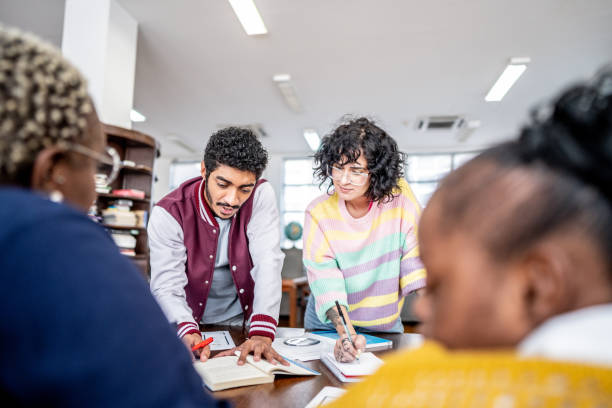 istock Friends studying together in the library 1493265745