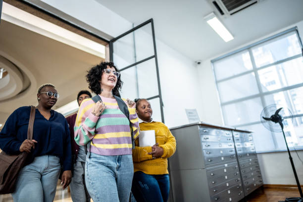 istock Friends walking and talking in the library 1493266658