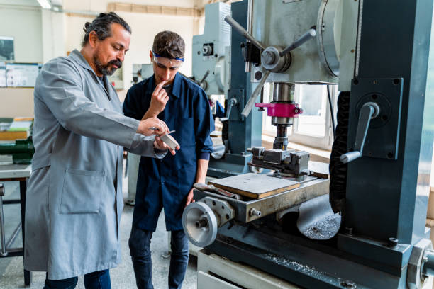 istock teenage boy in technical vocational training with teacher 1493271455