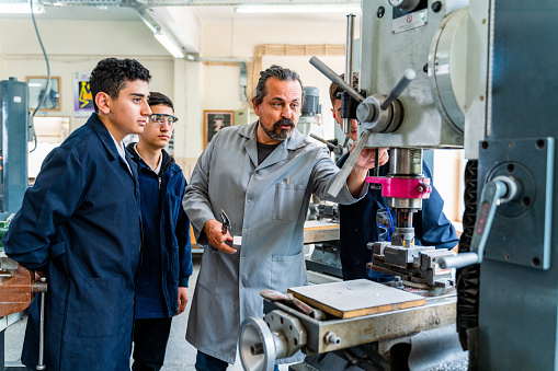 Group of young people in technical vocational training with teacher