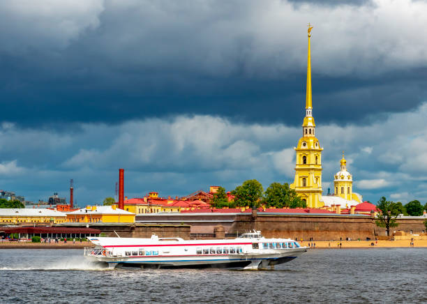 Peter and Paul cathedral and boat on Neva river, Saint Petersburg, Russia Peter and Paul cathedral and boat on Neva river, Saint Petersburg, Russia peter and paul cathedral st petersburg stock pictures, royalty-free photos & images