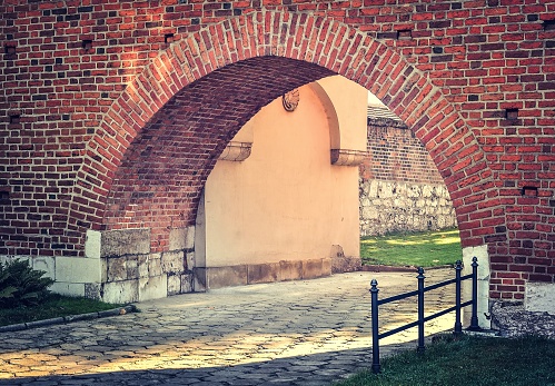 Footpath with archway made of brick. Photo taken in Krakow, Poland.
