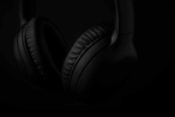 istock Black headphones on a black background 1493277345